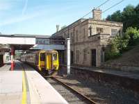 Although the former Platform 6 at Lancaster Castle is disused the first floor of the original station building is still the booking office, operated by Virgin, and from where the platforms are accessed via the footbridge. 156480 stands in Platform 5 waiting to form a Northern service to Barrow in Furness in this view looking northwards. <br><br>[Mark Bartlett 31/07/2009]