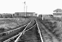 An EE Type 3 heads south towards the Tyne in 1971 with a coal train, probably from Burradon exchange sidings. The train is about to pass Earsdon Junction signal box. The flat crossing is a mineral line (the Backworth Wagonway) serving East Holywell Colliery.<br>
<br><br>[John Furnevel 19/10/1971]