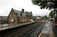 The beautifully restored station building and signalbox stand on the north side of the line at Parbold between Southport and Wigan on 26 August 2009. The end of the station building nearest the camera is still in use as ticket office, waiting room and toilets.<br><br>[John McIntyre 26/08/2009]