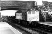 25153 brings its train of ballast hoppers to a halt in Burscough Bridge station, prior to setting them back onto the Burscough Junction chord to allow a DMU to pass [See image 22975]. The chord has since been lifted and the <I>Rip Raps</I> no longer clatter round the North West. 25153 was withdrawn in 1983, after some 19 years service, and cut up at Swindon four years later.<br><br>[Mark Bartlett 03/11/1980]