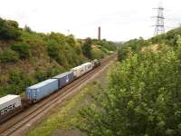 66537 heads east towards Normanton, & Leeds Freightliner Terminal, passing the former Goose Hill Junction. The old Midland main line trackbed runs to the right of the existing line. <br><br>[David Pesterfield 04/09/2009]