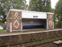 Decorative east-bound waiting shelter at Plumley Station on Stockport to Chester line, with long bench seat along most of back wall. <br><br>[David Pesterfield 01/09/2009]