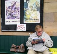 <I>The enthusiast #2.</I>  A passenger awaiting the next NYMR train to Whitby at Pickering on 12 October 2009 appears to be engrossed in a recent purchase from the station bookshop. The WWII posters in the background are part of the preparations for the annual <I>1940s Wartime Weekend</I> held locally. (The book in question is <I>Historic Steam Boiler Explosions</I> by Alan McEwen.)  <br>
<br><br>[John Furnevel 12/10/2009]