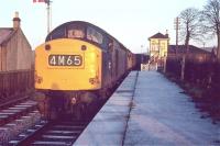 An EE type 4 with a freight, (carrying members of Edinburgh University Railway Society) at Heriot station in December 1968. What appears to be a white circle on the front of the locomotive is in fact a bung, inserted into the hole which had been bored to accommodate a cable for communication with the loco crew on the occasion of a previous Royal Train assignment.<br><br>[Bruce McCartney /12/1968]