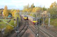 A pair of 320s passing at Sunnyside Junction, just to the west of Coatbridge Sunnyside station, on 28 October 2009. The line south to Whifflet Junction can be seen turning off bottom left here, while in the centre right, hidden behind the trains, is the remains of the junction that latterly served Gunnie Yard and Gartsherrie Cement Works to the north. In the centre left of the picture is part of the Summerlee Industrial museum site.<br><br>[David Panton 28/10/2009]