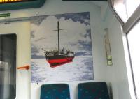 One of the picture panels carried by Class 320s since delivery in 1989. Henry Bell's <I>Comet</I> of 1812 was not the world's first paddle steam vessel but is reckoned to be the first commercial one in Europe. It was built in Port Glasgow and operated on the Clyde. In order to show the paddles the artist has opted to depict the vessel clear of the water, with the part that would normally be below the waterline coloured red. However, together with the background, this does give it the slightly disturbing (or <I>bad trip</I>) appearance of hovering above the water. <br>
<br><br>[David Panton 28/10/2009]