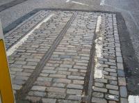 The remnants of Edinburgh's cable-car system in Waterloo Place, looking east on 17 November 2009. Notice the central slotted rail within which the cable ran. Edinburgh's first cable hauled 'tramcar' ran in 1888 with the system operating for 35 years until eventually being converted to electric traction (which had been employed by Leith Corporation to operate its trams since 1905). [See image 26669]<br>
<br><br>[John Furnevel 17/11/2009]