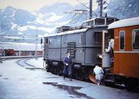 Snow-capped mountains form the backdrop at Myrdal, Norway, in 1967 as the crew prepares to uncouple the locomotive that has hauled the train up from Flam.<br>
<br><br>[Colin Miller /07/1967]