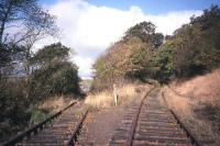 Not the most well-known of railway locations, partly due to its military associations - Braeside Junction on the Charlestown branch, looking north towards the RNAD terminus at Crombie (the left-hand line) and Elbowend Junction (the right-hand line) on the Dunfermline-Kincardine line. The branch headshunt and buffer stops are behind the photographer. This is 1998, by which time all the permanent way seen here had been mothballed for a number of years.<br><br>[David Spaven //1998]