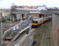 In this view from the east, Exhibition Centre station presents a <br>
deceptively junction-like appearance. In fact the track on the far left is a siding, and platforms 2 and 1 serve the Argyle Line westbound and eastbound respectively. The westbound track remains in the open and joins the North Clyde Line at Finnieston East Junction, while the track from Finnieston West has had to burrow under the North Clyde Line (among other things) in the 950yd Kelvinhaugh Tunnel which opens straight onto Platform 1. From there 318261 departs for Larkhall on 20 January. <br>
<br><br>[David Panton 20/01/2010]