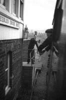The driver of the 0744 Edinburgh-Peebles-Galashiels DMU exchanges single line tokens with the signalman at Peebles Engine Shed signal box on 3 February 1962, the last day of passenger services on the line.<br><br>[Frank Spaven Collection (Courtesy David Spaven) 03/02/1962]