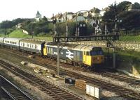 English Electric Class 50 No. 50022 <I>Anson</I> draws forward under an impressive lower quadrant signal gantry at the west end of Newton Abbot in the summer of 1986. The train is an evening service from the Plymouth line and heading for Paddington. <I>Anson</I> was withdrawn in September 1988 and cut up at Vic Berry's yard in Leicester the following year.<br><br>[Mark Bartlett /07/1986]