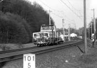 A DB track machine moving west from Bunde (Westfalen) in April 1976 on the main line towards Osnabruck. <br>
<br><br>[John McIntyre /04/1976]