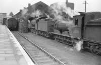 The south east corner of St Boswells in the summer of 1958, with J38 0-6-0 no 65934 and J36 0-6-0 no 65316 on shed alongside the station's bay platform. [See image 17121]<br><br>[Robin Barbour Collection (Courtesy Bruce McCartney) 15/07/1958]