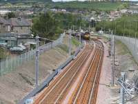 A DBS class 66 on the rear of a PW train stands on the new down line on 17 May 2010 after delivering CWR. View from Whitburn Road bridge back towards Bathgate. <br><br>[James Young 17/05/2010]
