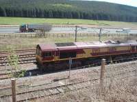 DBS 66106 waits alongside the M74 in the northbound loop at Beattock Summit for a Pendolino to overtake. The loco was hauling a lengthy train of bogie tankers. <br><br>[Mark Bartlett 18/05/2010]
