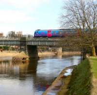 Immediately after leaving York station, the 1347 Liverpool Lime Street - Scarborough service turns east and crosses the River Ouse. View is south along the river on a pleasant 21 March 2010, with part of York Minster visible in the left background. <br>
<br><br>[John Furnevel 21/03/2010]