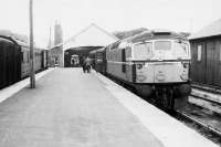 A train for Inverness waits to leave Thurso behind a BRCW Type 2 in July 1963.<br>
<br><br>[Colin Miller /07/1963]
