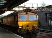 A ballast train heading north through Perth station on 26 June behind locomotive 66114.<br><br>[Brian Forbes 26/06/2010]