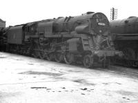 Crosti-boilered BR Standard class 9F no 92020, sporting a 15A shed plate, on its home shed at Wellingborough around 1960 - obviously in course of 'receiving attention'. <br><br>[K A Gray //]