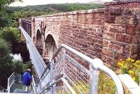 <I>'After you dear...'</I> Tentatively trying out the pedestrian footbridge (completed 1999) alongside the Oykel Viaduct on the walk from Culrain to Invershin in September 2001. The metal footbridge is bolted onto the west side of the viaduct.<br><br>[John Furnevel 14/09/2001]