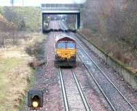 A class 66 heading back to Millerhill Yard light engine slows on the approach to Niddrie South junction on 10 December 2002.<br><br>[John Furnevel 10/12/2002]