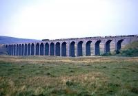 A steam-hauled freight heads north over Ribblehead Viaduct in the 1960s.<br><br>[Robin Barbour Collection (Courtesy Bruce McCartney) //]