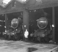 Steam on shed at 26A, Newton Heath, in 1967, the year before closure. Stanier 8F 2-8-0s 48356 and 48665 stand either side of a youthful JP.  <br><br>[Jim Peebles Collection //1967]
