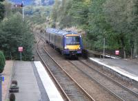 170 419 approaches Dunkeld with a busy (as always) Inverness to <br>
Edinburgh service on 20 September. This track is bidirectional and is used by all passenger services except the one a day which needs to cross here, and the odd special [see image 20750]. The difference in track usage is obvious, and the approach signalling shows that Platform 2 is not bidirectional but Down only.<br>
<br><br>[David Panton 20/09/2010]