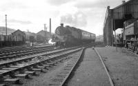 Standard class 4MT 2-6-4T no 80070 takes a train away from Oswestry on the old Cambrian line to Whitchurch on 2 April 1963. The train is about to pass Oswestry shed on which a 14XX 0-4-2T and a pannier tank can be seen.<br>
<br><br>[K A Gray 02/04/1963]
