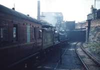 Caley 123 and NB 256 leave Kelvin Hall heading west. The station was<br>
renamed from Partick Central in advance of the 'Scottish<br>
Industries Exhibition' in September 1959, during which time a two week programme of 'Excursions by Historic Locomotives' was run in connection with the exhibition. The photograph is taken from the west end of the island platform. The scrapyard in the background remained in operation until the 1990s.<br><br>[A Snapper (Courtesy Bruce McCartney) /09/1959]