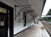 A look south along the Platform 1 at Dunkeld on 20 September. The line is bidirectional and the platform is used by all services except one each weekday. The station may look like it is staffed, but in fact is hasn't been manned for some years though this building is occupied. Notice that some of the canopy brackets seem to have had their ornate mouldings knocked out and replaced with something more utilitarian. Note also the wooden steps on platforms which are below standard height. The sign on the door reads <I>Private offices leased from British Rail. It is regretted that there are no facilities for the travelling public</I>. <br>
<br>
<br><br>[David Panton 30/09/2010]