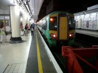 A 377 for Portsmouth and Southsea prepares to leave platform 18 at Victoria in July 2010.<br><br>[Ken Strachan 03/07/2010]