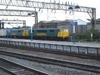 Freightliner 86639 leads sister locomotive 86621 through Manchester Piccadilly platform 14 early on the evening of 2 September 2010 with an intermodal working bound for Trafford Park terminal. <br><br>[David Pesterfield 02/09/2010]