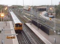 A 6-car EMU leaves Kirkdale and heads for Liverpool passing the EMU depot, although this being the <I>rush hour</I> there is only one train in the sidings. Picture taken from the modern street level bridge that also carries the ticket office.<br><br>[Mark Bartlett 21/10/2010]
