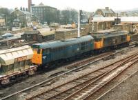 31319 leads 31202 eastbound through Skipton station in March 1988 with a loaded Tilcon working from Swinden Quarry. 08707 stands in the siding in the centre background.<br><br>[David Pesterfield 22/03/1988]