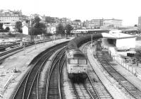 A 47 hauling oil tanks (probably empties) West through Newport in the dim and distant late eighties. Just out of shot to the right is the old goods yard [see image 30821], which was later redeveloped as a shopping centre, while the bus station was revamped over half a mile away. No transport interchange planning there.<br><br>[Ken Strachan /08/1987]