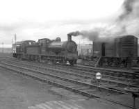 The north end of Inverurie station on 26 March 1959 sees J36 0-6-0 no 65303 engaged in manoeuvres in conjunction with Barclay no D2414 prior to taking out a freight.  The Barclay (diesel mechanical)   shunter, which entered service early in 1959, has no coupling rods and looks to be in course of delivery.<br><br>[Robin Barbour Collection (Courtesy Bruce McCartney) 26/03/1959]