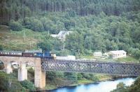 A train on the Far North line about to cross the Oykel Viaduct over the Kyle of Sutherland between Invershin and Culrain in 1975. <br><br>[Ian Dinmore //1975]