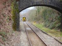 A 158 on a Maesteg to Cheltenham service approaches Sarn, where it will form the 10.32 departure. The unit is passing a lower quadrant home signal protecting the junctions at Tondu.<br><br>[David Pesterfield 10/03/2011]