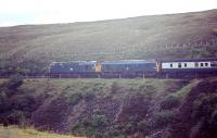 Photograph taken from alongside the A9 south of Dalnaspidal in 1969 showing D5339 + D5120 with a southbound train from Inverness.<br><br>[Bruce McCartney /08/1969]