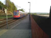 A Sheffield 'Supertram' heads North along the tracks above the retaining wall to the East of Sheffield station on 24 April 2011. <br><br>[Ken Strachan 24/04/2011]