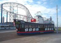 'L' Plates displayed but is that for a tram driving licence or a skipper's ticket? <I>Trawler Tram</I> 737, promoting Fleetwood based 'Fisherman's Friend' lozenges, is on training duties at the Pleasure Beach turning circle but being driven from the <I>stern end</I>. After several years out of service the tram was restored for the 2016 illuminations.<br><br>[Mark Bartlett 11/05/2011]