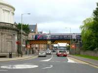 Having just crossed the River Tay, an afternoon Aberdeen - Glasgow Queen Street service now crosses a Street with the same name in July 2006. The train is about to pass through the remains of the former Perth Princes Street station [see image 9931] which stands behind the Fergusson Gallery on the left.<br><br>[John Furnevel 15/07/2006]