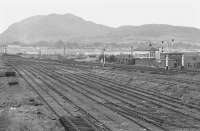 A scene of dereliction at Niddrie West Yard in 1974 with Arthur's Seat dominating the background. Niddrie West signal box still stands over on the right. [See image 32503]<br><br>[Bill Roberton //1974]