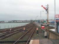 Looking back along the breakwater from the platform end at Harbour station towards Stranraer itself. This picture shows the one line that remains in regular use, the switched out signals and the other rusty (although still usable) track and pointwork. <br><br>[Mark Bartlett 25/05/2011]