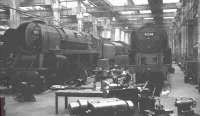 BR Standard class 9F 2-10-0s nos 92211 & 92205 receive attention in the workshops at York in May 1964.<br><br>[K A Gray 02/05/1964]