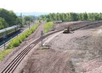 View south over the site of the old down yard at Millerhill on 3 June 2011 with West Coast Railway 57001 passing on the left with the empty stock of <I>The Royal Scotsman</I>. The line curving off to the right is part of the new Borders Railway route heading for what will be its next station at Shawfair. Part of the new Shawfair development will occupy the site of the former Monktonhall Colliery. The short section of new track is currently being used as a replacement turnback siding for trains terminating at Newcraighall. [See image 4433] for the view thirty years earlier.<br>
<br><br>[John Furnevel 03/06/2011]