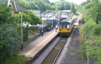 A Class 142 unit calls at Brierfield station with a service to <br>
Blackpool South on 9 July 2011. The view is south and at the far end of the platform is the level crossing over the B6248 Clitheroe Road and the signalbox controlling the barriers.<br>
<br><br>[John McIntyre 09/07/2011]