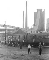 The BLS 'Forth Fife Railtour' stands in front of Alloa glassworks on 28 August 1976. The works stood alongside the branch which left the current main line at Alloa Harbour Junction and ran south to Alloa Ferry passenger station. Alloa Ferry was the original and short lived (June 1851 - July 1852) terminus of the line pending the extension west to Stirling [see image 17758]. The final section of the Harbour branch closed in 1978.<br><br>[Bill Roberton 28/08/1976]
